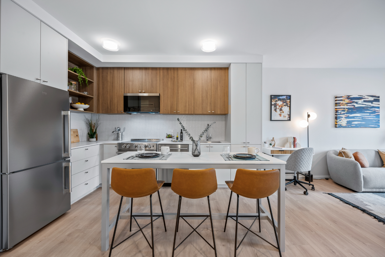 Open-concept living area with modern kitchen finishes.